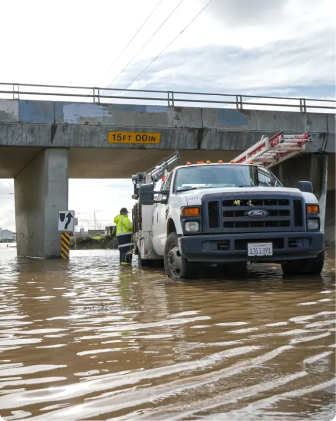 City of Stockton employee working in flooded street