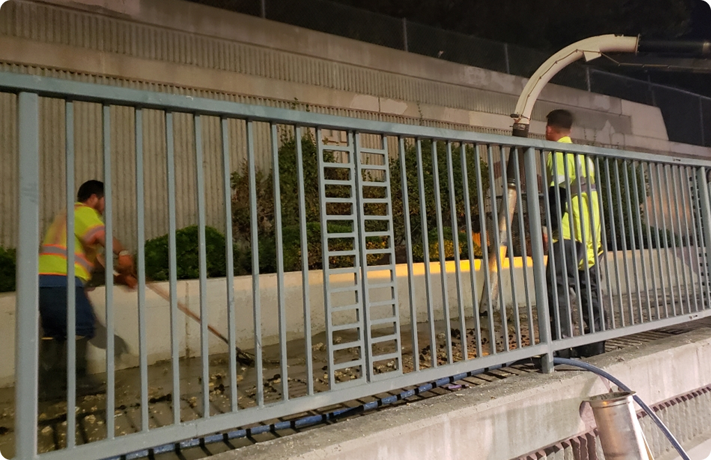 workers cleaning storm drain